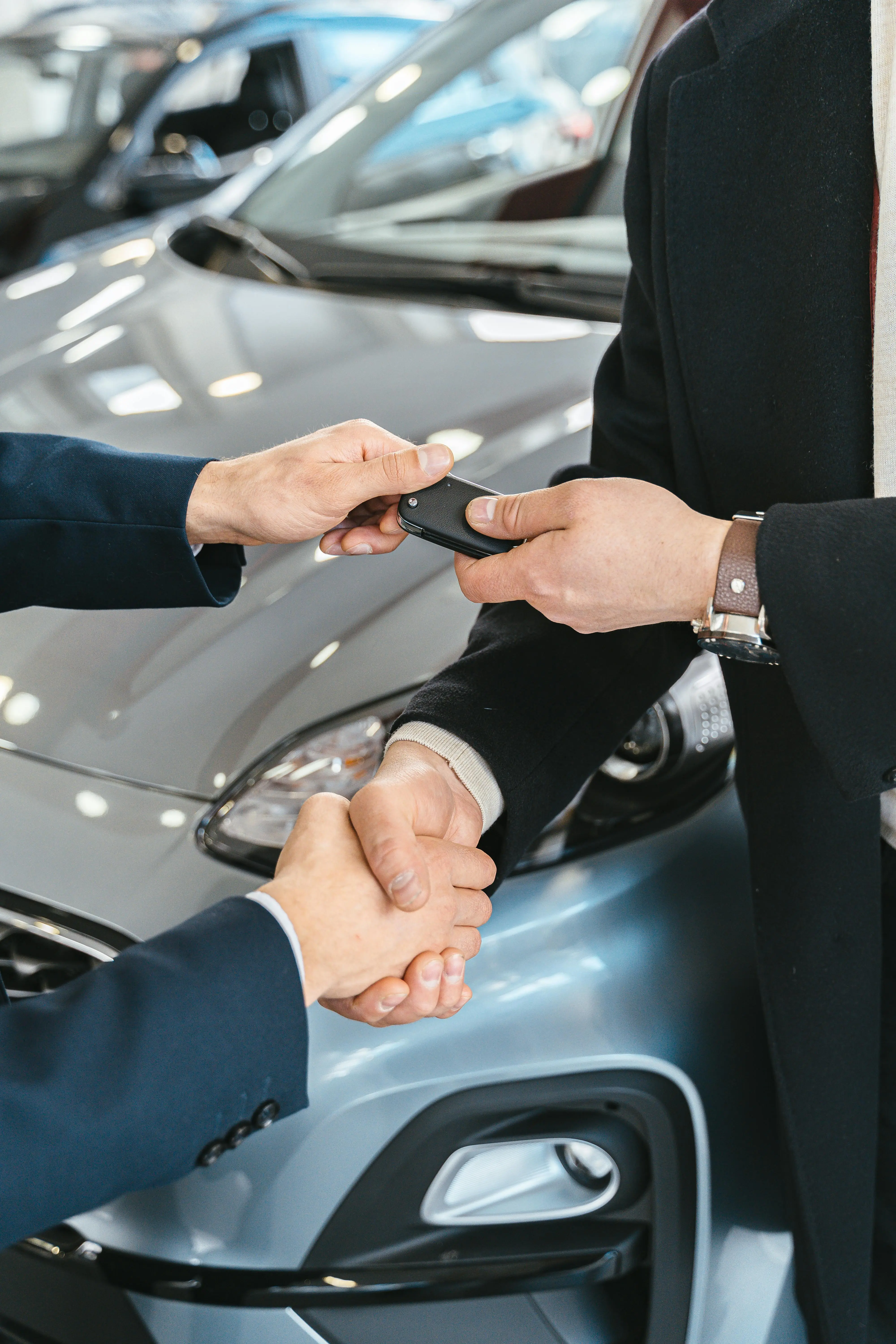 A dealership handoff moment with a new vehicle owner